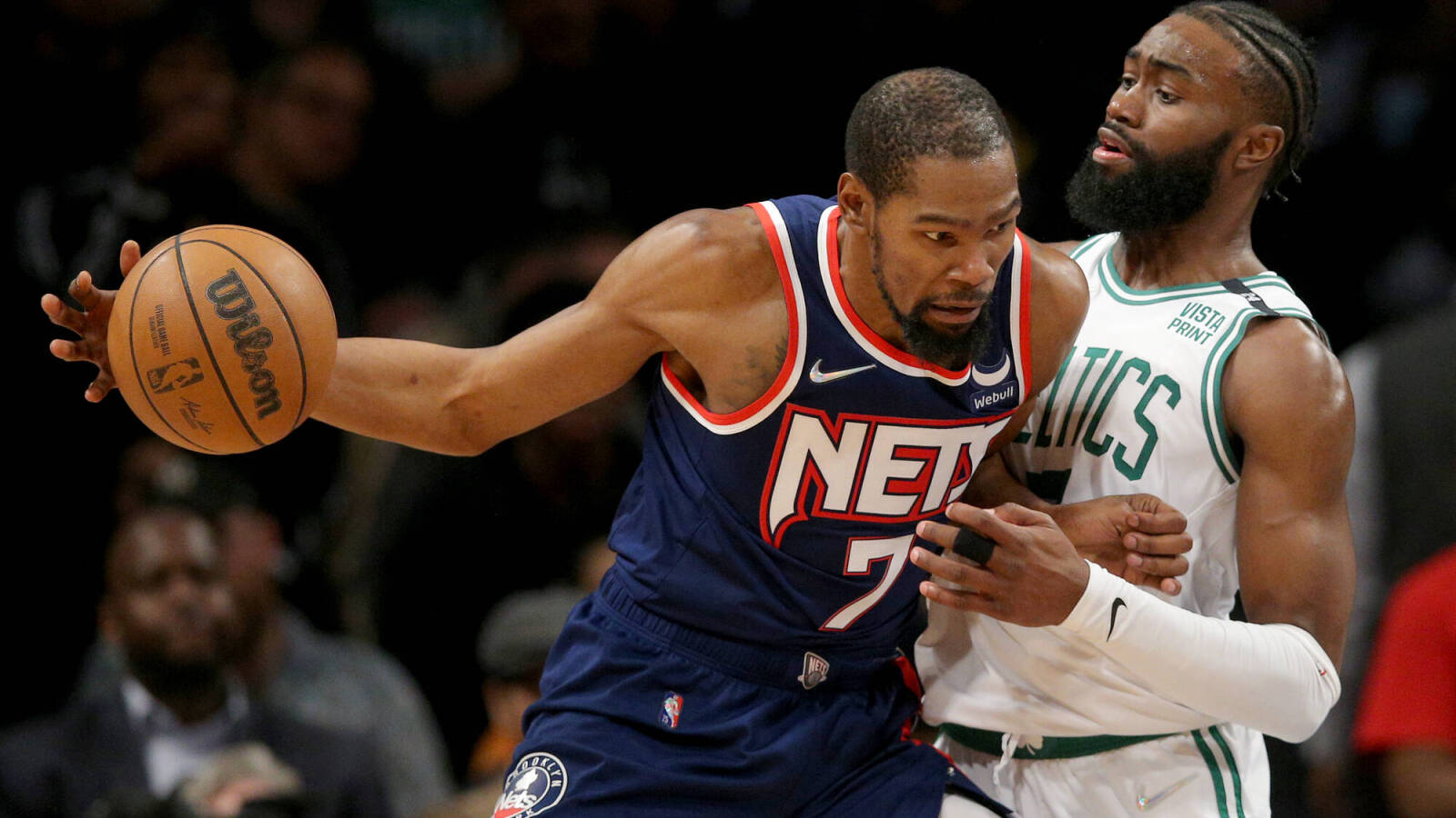 Nets' Kevin Durant backing down Celtics' Jaylen Brown.
