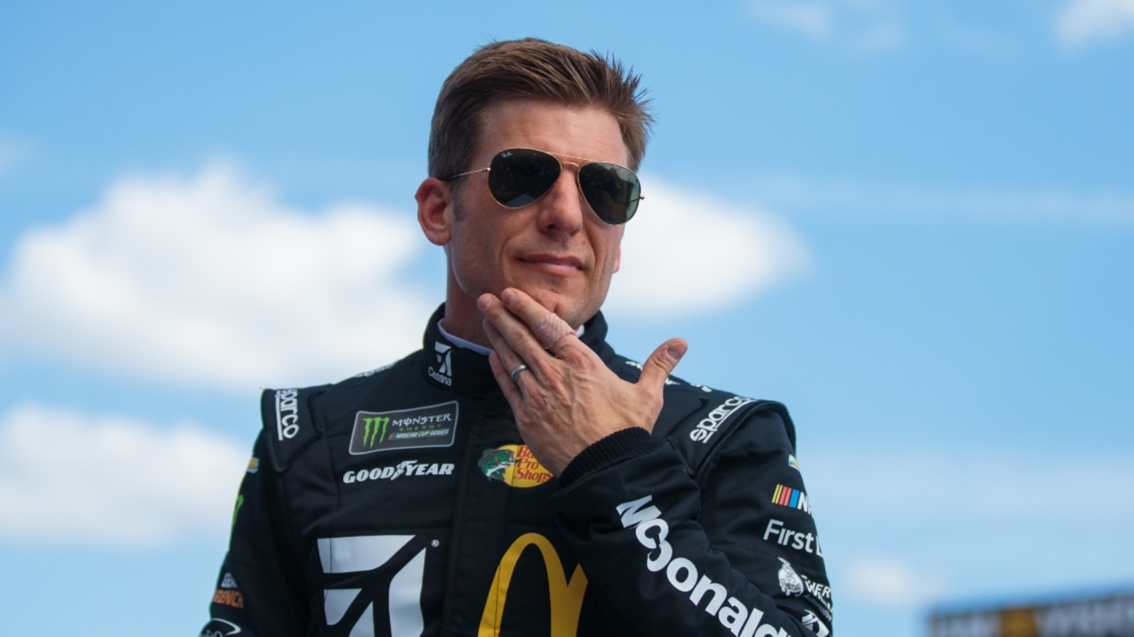 Jamie McMurray holds, bottle-feeds baby kangaroo during NASCAR race at Texas Motor Speedway