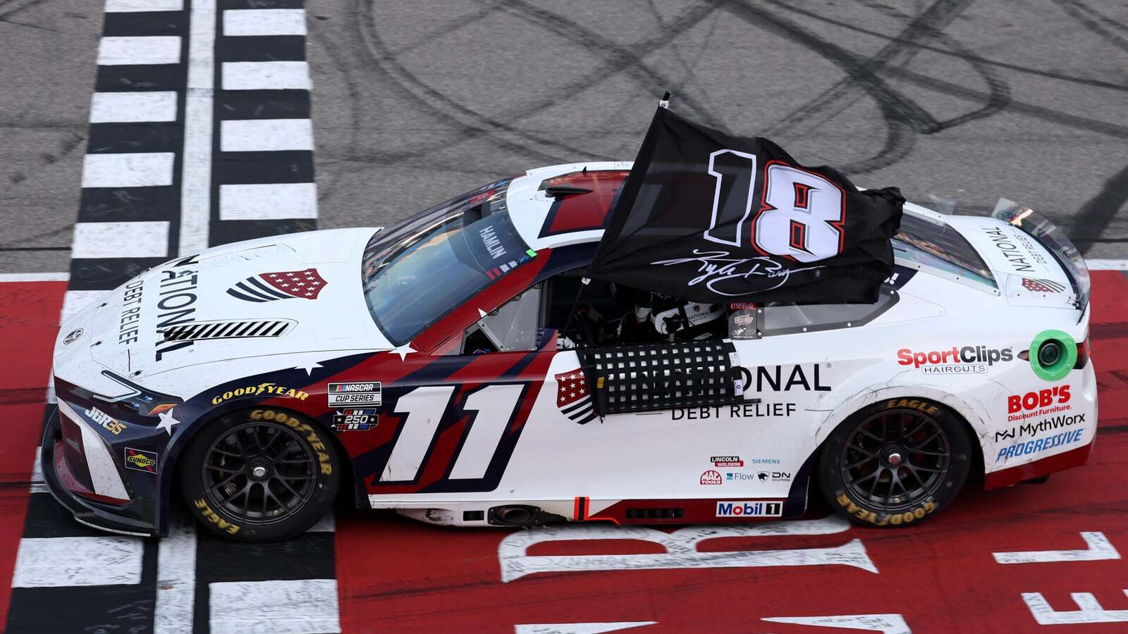 Denny Hamlin used unique flag to pay tribute to Kyle Busch after FireKeepers Casino 400