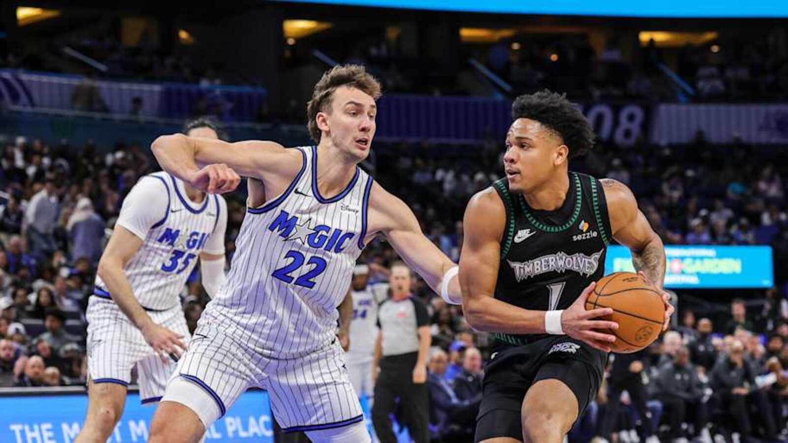 Franz Wagner in Orlando Magic uniform faces a Minnesota Timberwolves defender
